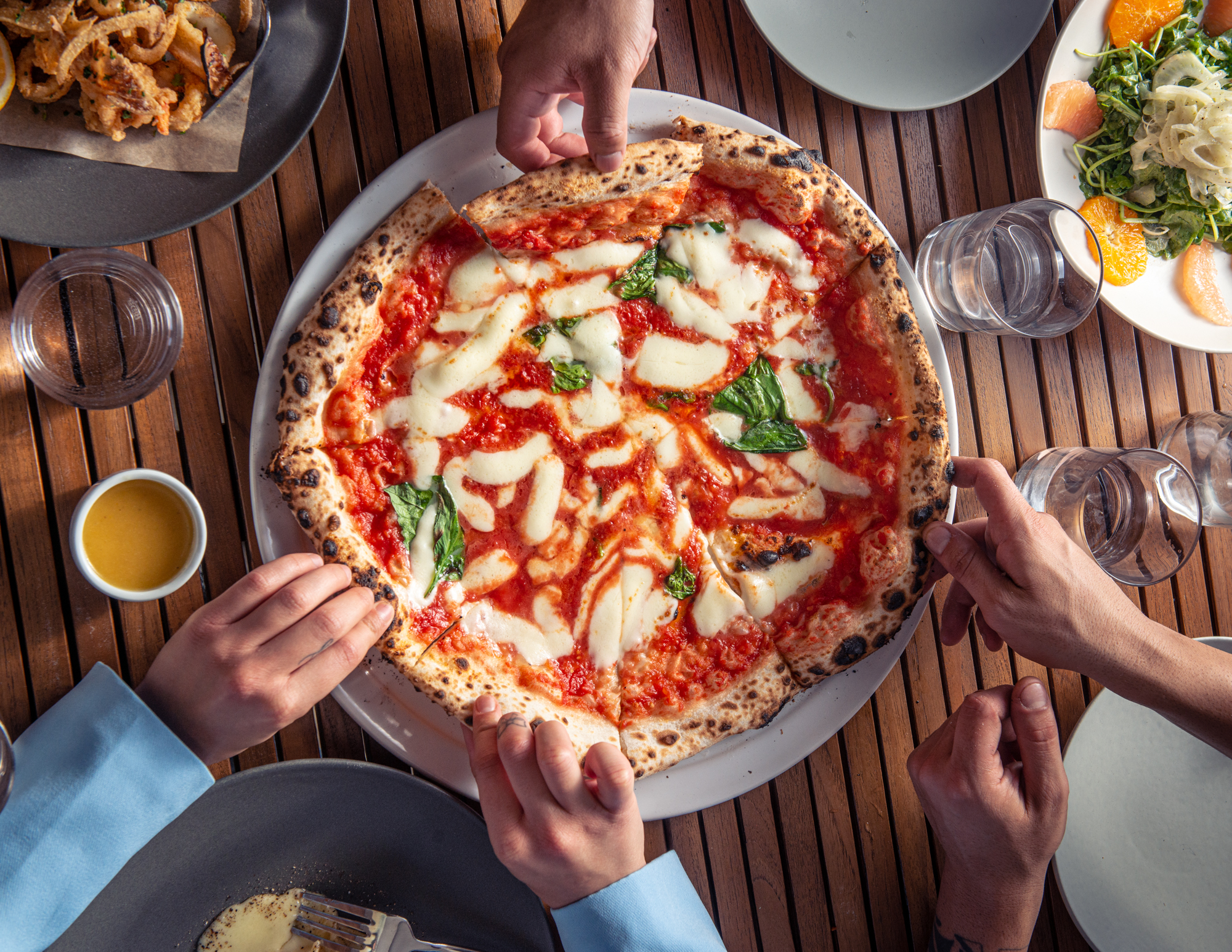 Wood-fired pizza sharing